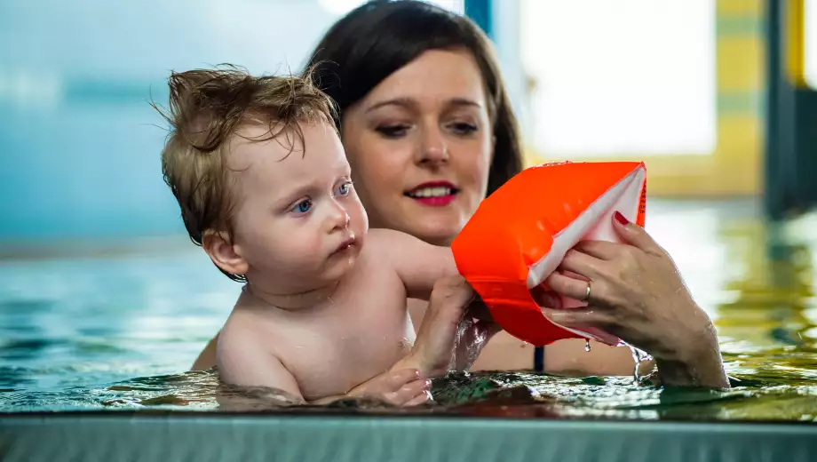 Mom puts baby's water wings on