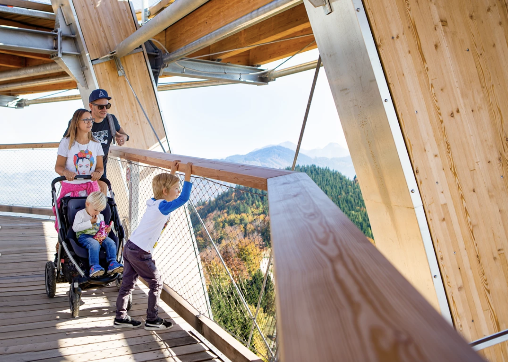 Family with children on the treetop path Salzkammergut in Upper Austria with a view of the Alps.