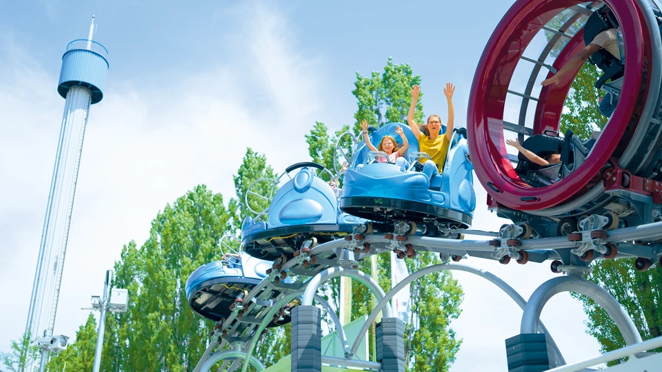 Woman and child in a car of the GraviTrax roller coaster