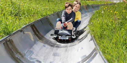 Ausflug mit Kindern - barrierefrei - Schweiz - Kinder am rodeln - Rodelbahn auf dem Gurten